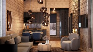 A modern living room with a sofa, chairs, a coffee table, and a fireplace. There are decorative lights and a television mounted on the wall.