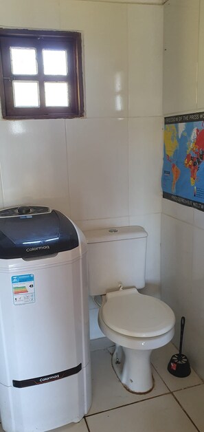 shower next to tanque and toilet