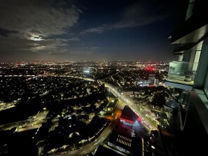 A nighttime aerial view of a cityscape with illuminated streets and buildings. - Impeccable 1bed Flat in West London!! (London)