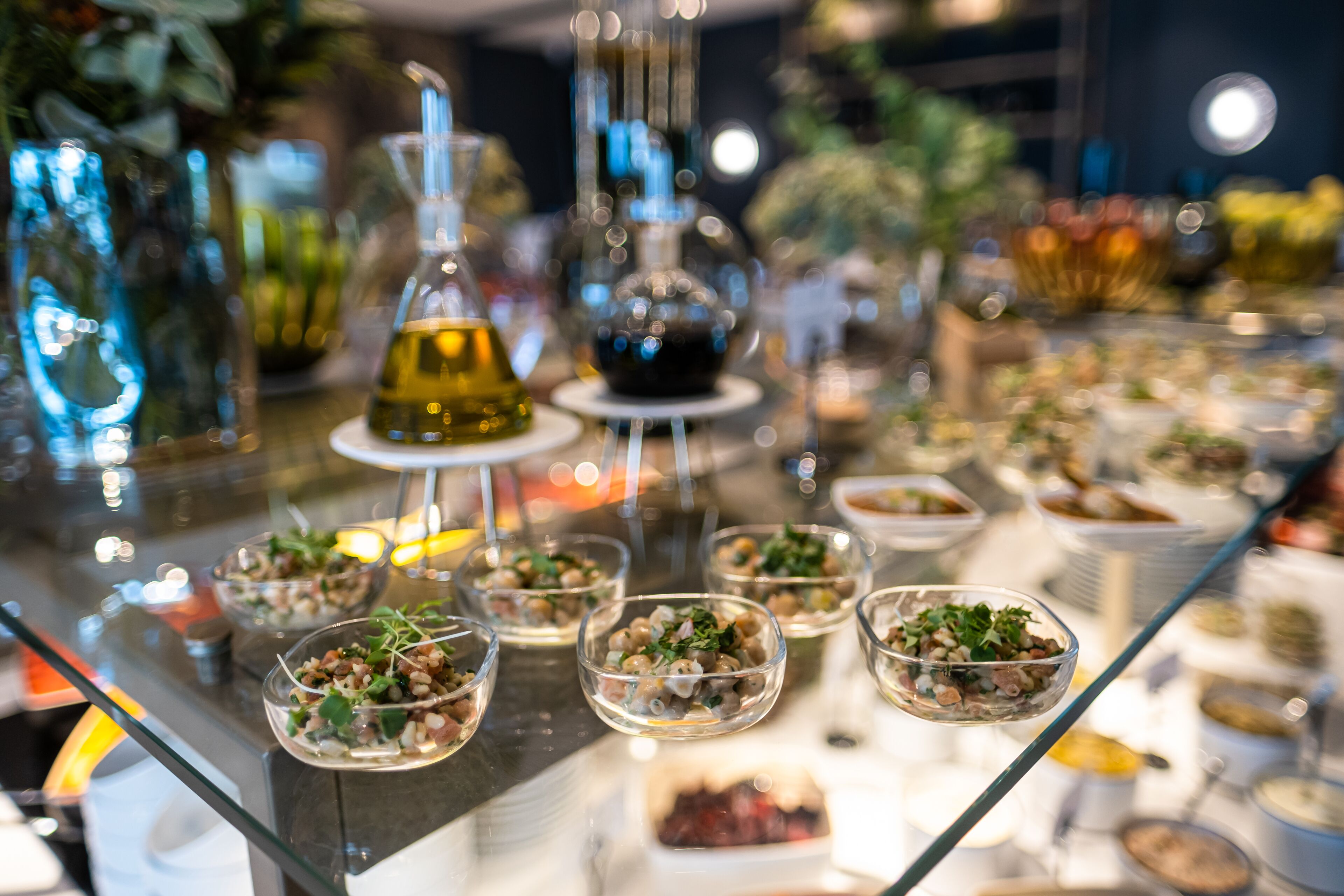 A glass display case with various food items and glassware.