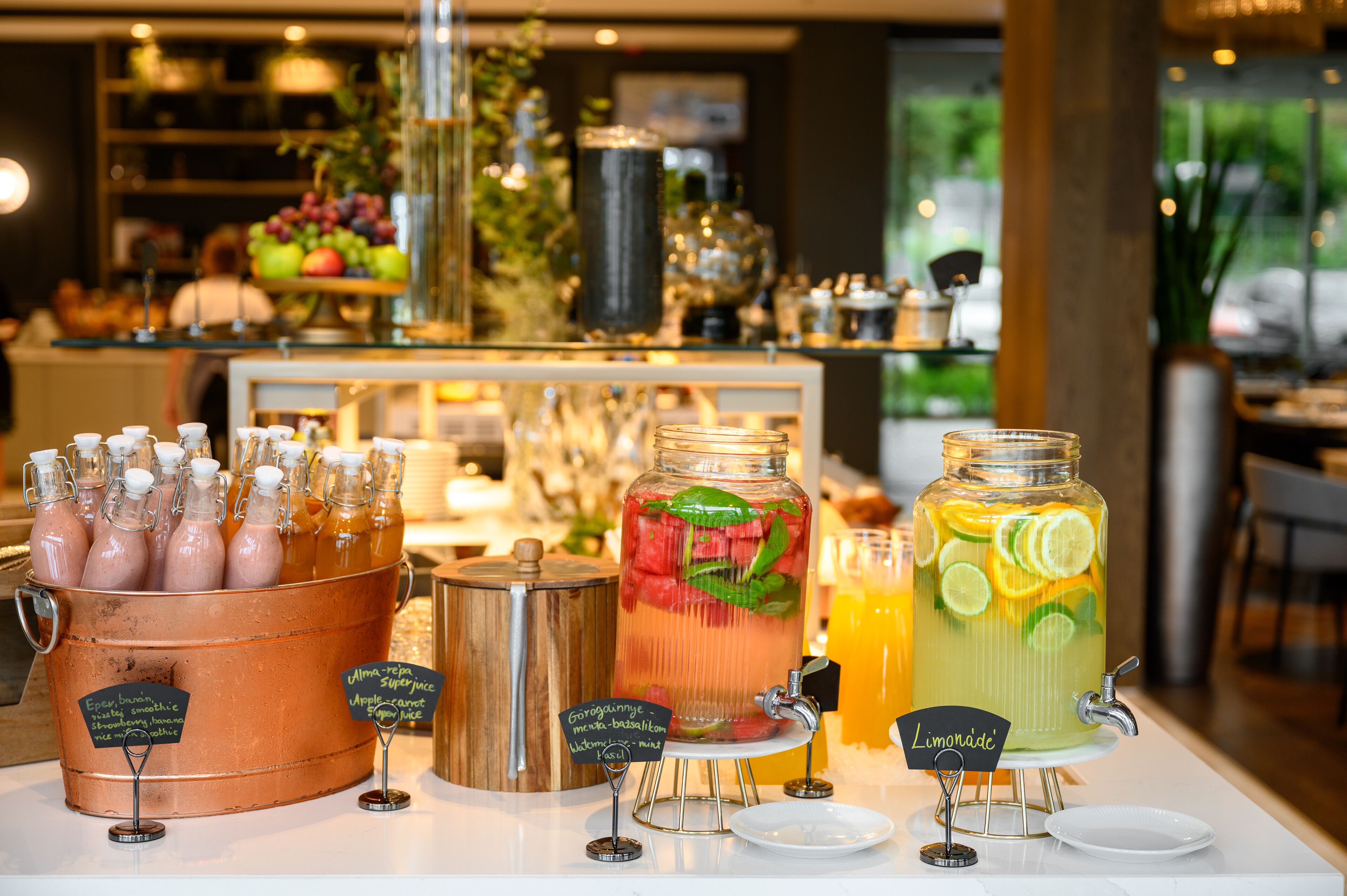 A beverage station with various drink options and labels.