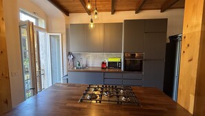 A modern kitchen with a gas stove, built-in oven, and microwave.