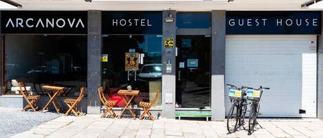 A hostel with outdoor seating and a guest house.