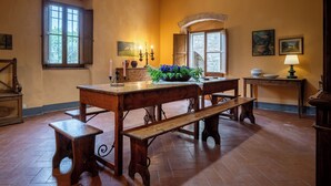 A dining area with a wooden table, benches, and a potted plant. - Belvedere - Ambra By Geco Vacation Rentals (Bucine)