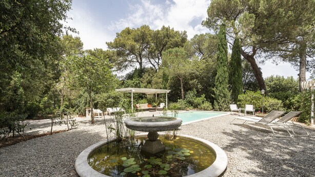 A garden with a circular pond, a pergola, and lounge chairs. - Villa Manfredi by Wonderful Italy (Fasano)