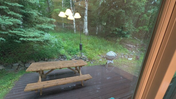 A wooden deck with a picnic table and a barbecue grill. - Waldheim Cottage: In-town bar Harbor Hideaway (Bar Harbor)