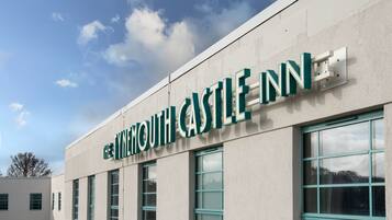The exterior of The Ynmouth Castle Inn with a clear sky.