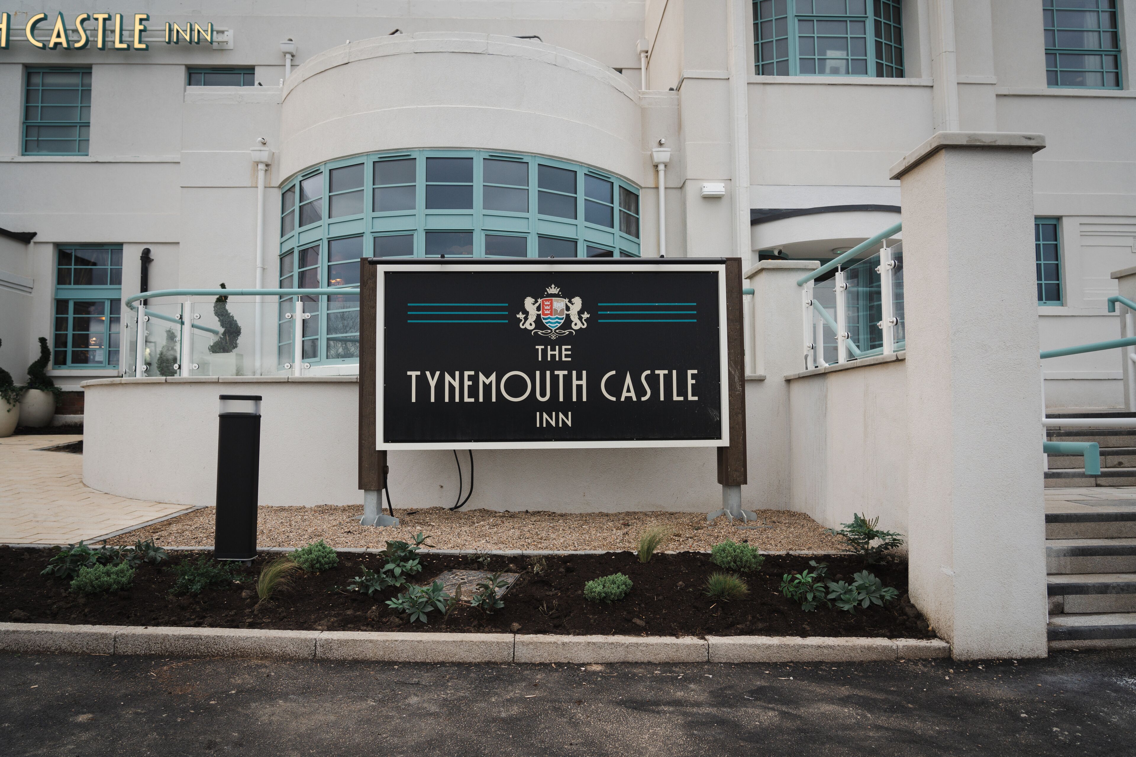 A sign for The Tynewish Castle Inn with a crest emblem.