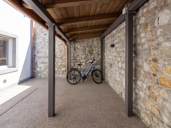 Relax in a serene outdoor space with a stone wall backdrop, perfect for a quiet moment.