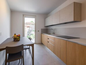 Enjoy a well-lit kitchen with a large window offering a view of the outdoor patio and table.