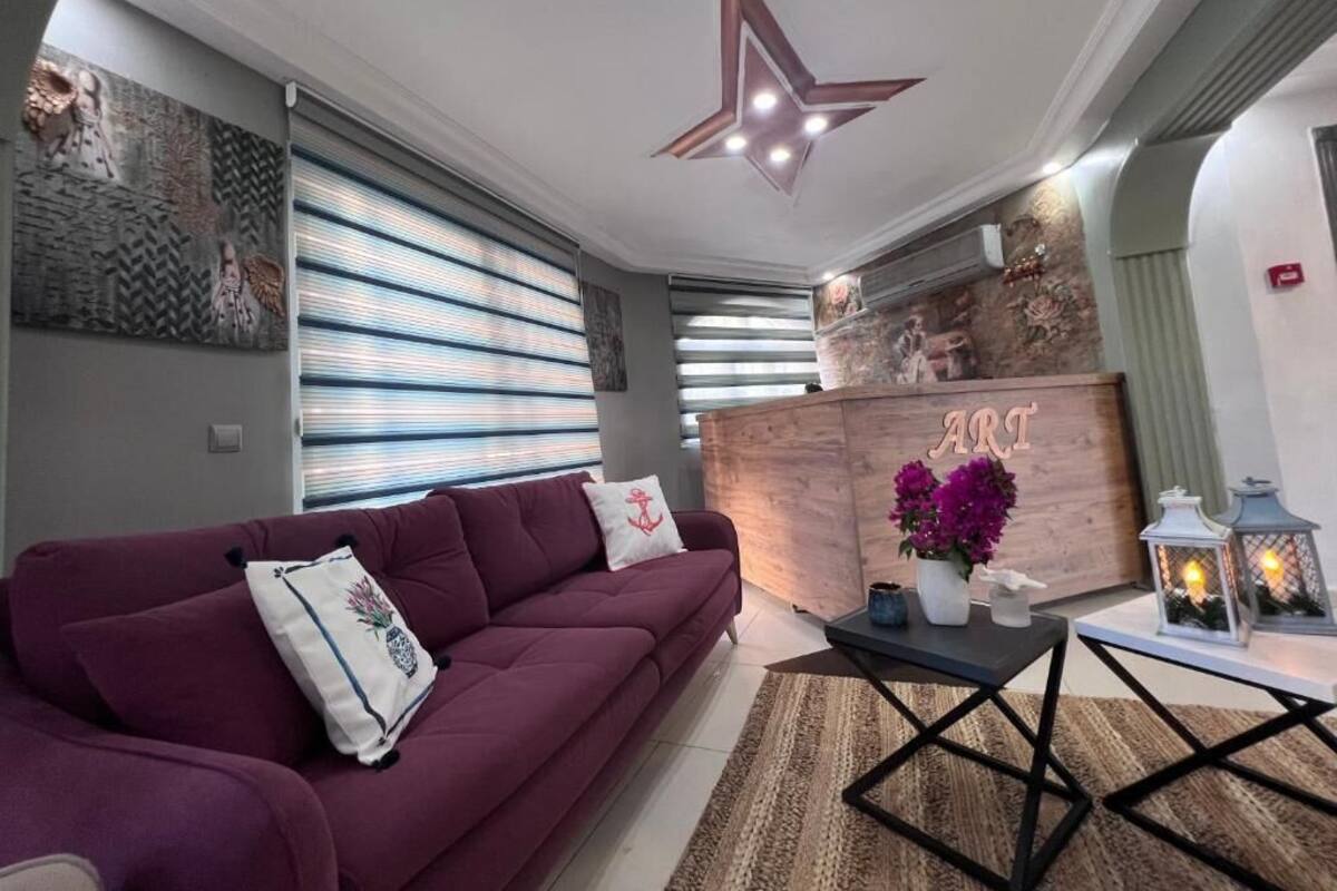 A modern living room with a sofa, a coffee table, and a decorative wall piece.