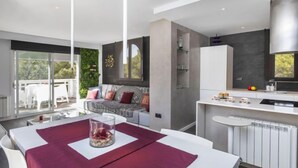 A modern kitchen with a white countertop, a built-in oven, and a large window. - Apartment Edison by Interhome (Peñiscola)