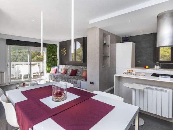 A modern kitchen with a white countertop, a built-in oven, and a large window. - Apartment Edison by Interhome (Peñiscola)