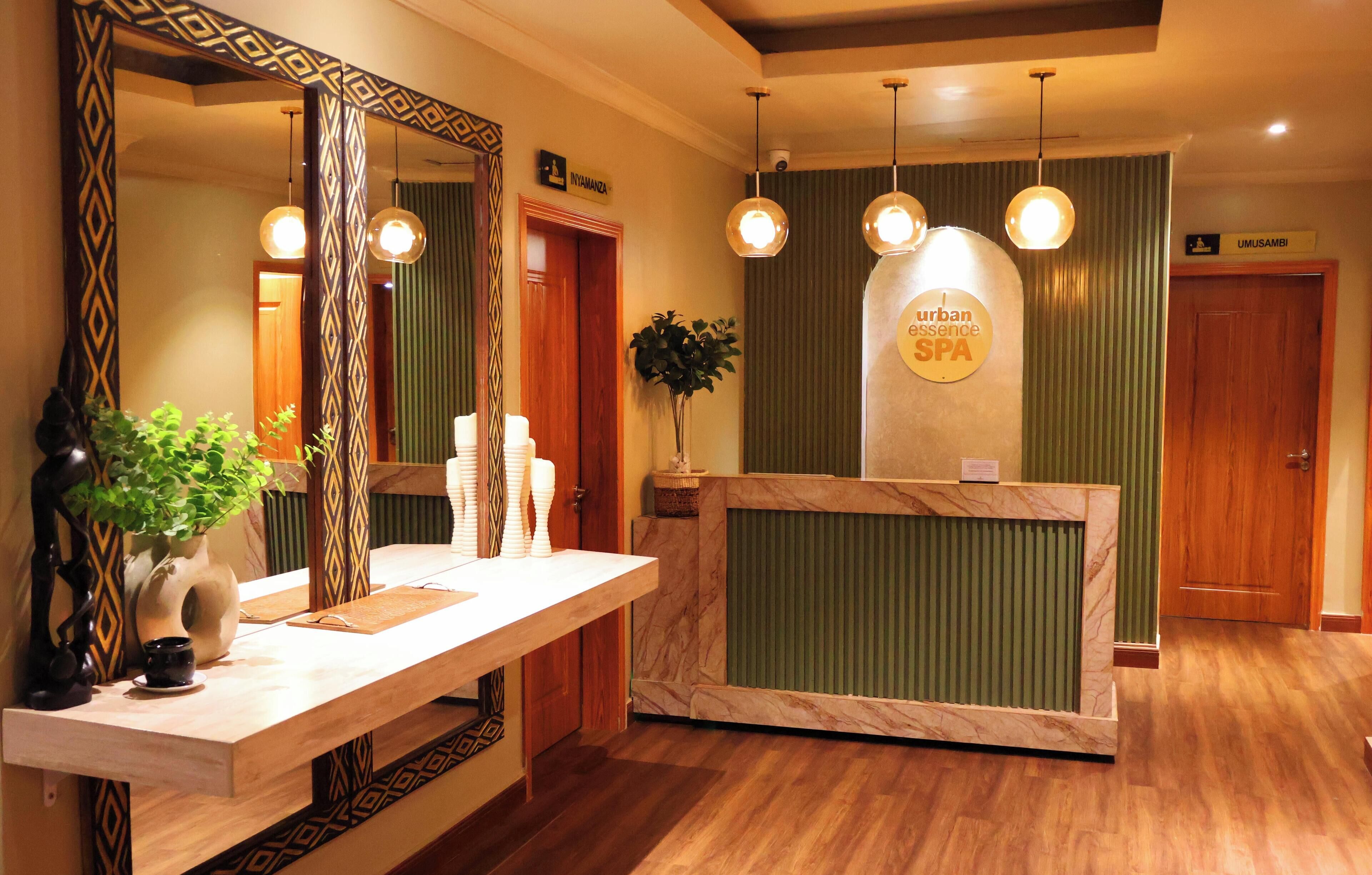 A reception area with a marble counter, a large mirror, and pendant lighting.