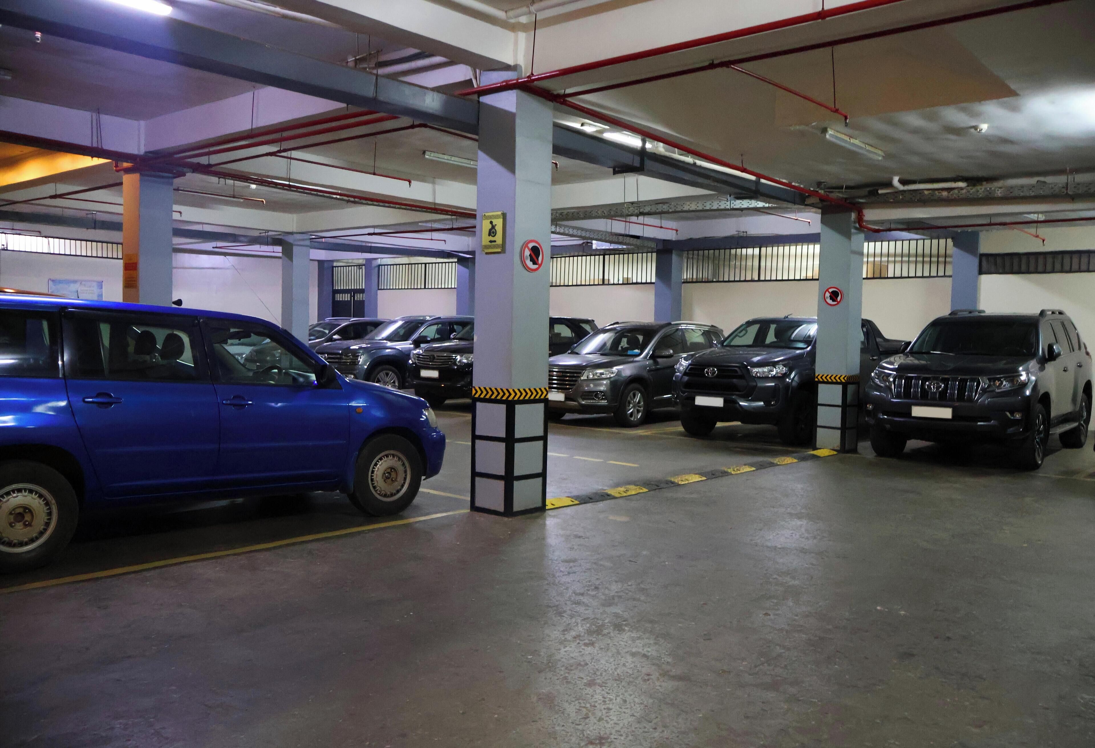 A multi-level parking garage with cars parked on various levels.
