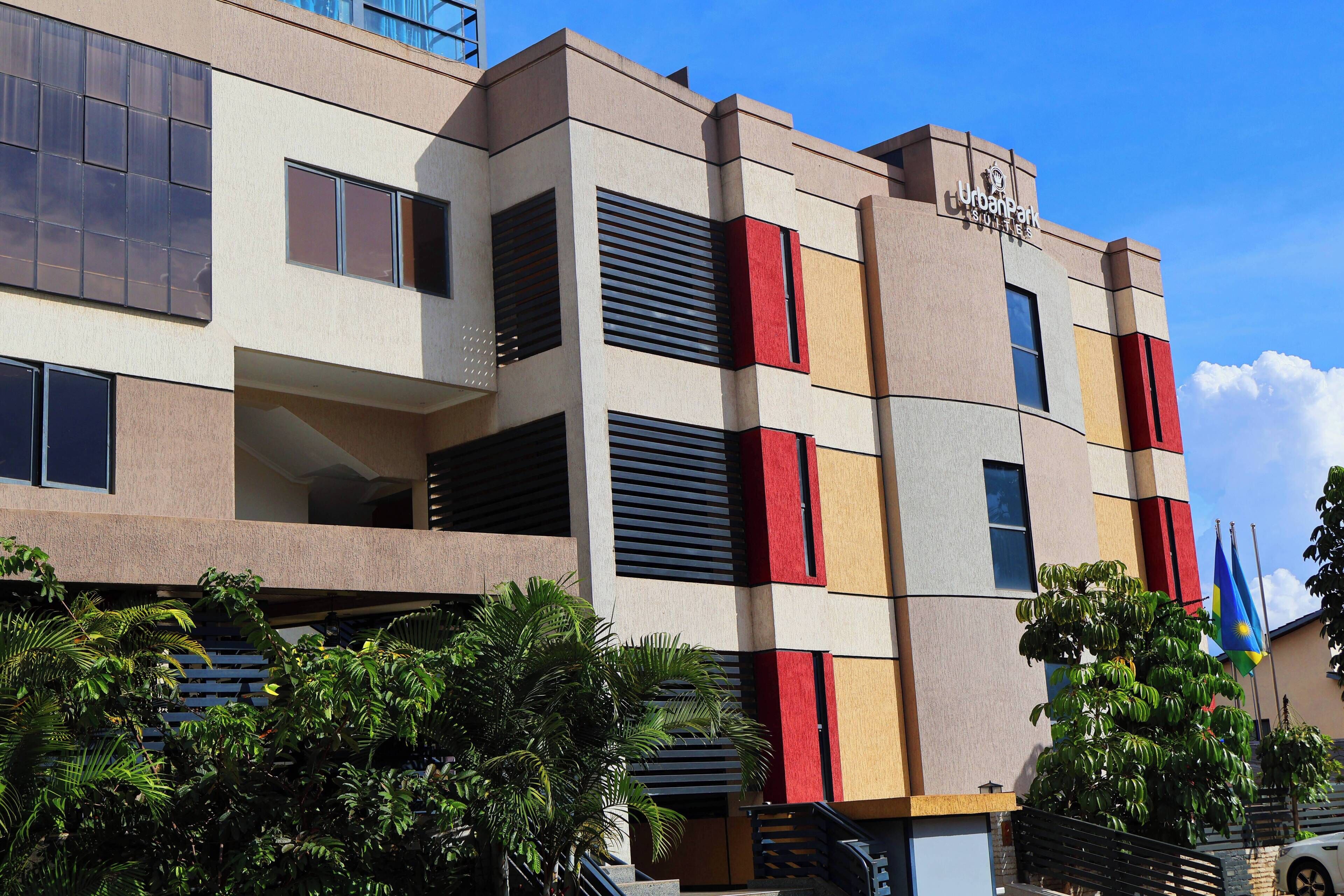 A multi-story hotel with a modern facade, balconies, and a flag.