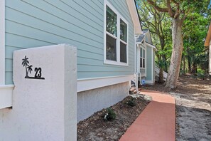 A house with a number 23 sign, a pathway, and a tree. - Stunning Renovated Designer Home At The Beach! (Isle of Palms)