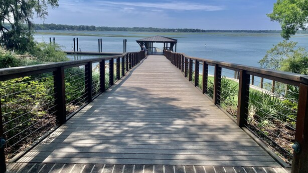 A wooden pier leading to a gazebo over a calm lake, surrounded by greenery. - "Nauti-Jayne" coastal cottage in Historic Old Town Bluffton (Bluffton)