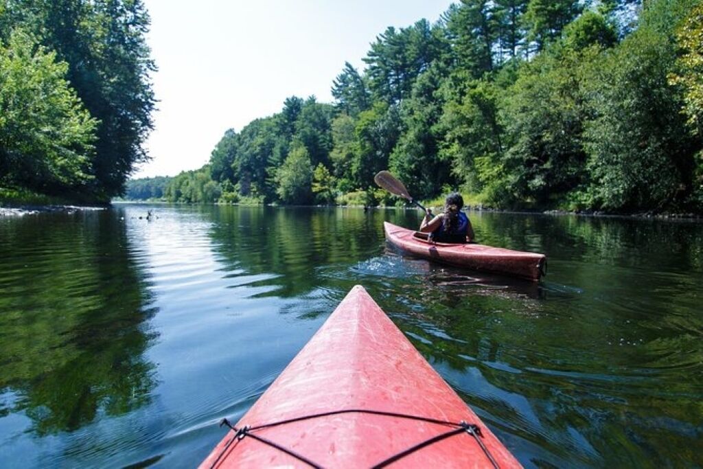 A calm river with kayaks.