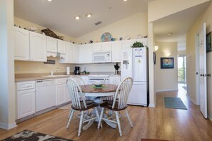 Enjoy cooking in this well-equipped kitchen with a central island, microwave, stove, and refrigerator.