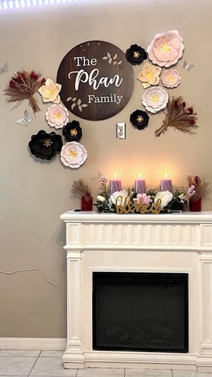 A fireplace mantel with candles and floral arrangements. - 4418 LOT #B Cozy 2BR Retreat 55” Smart TV & Workspace near DTLA 20 MI (El Monte)