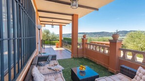 A balcony with outdoor seating, a view of the countryside, and a potted plant. - Bellavista Arriate by Ruralidays (Málaga)