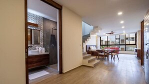 A modern interior with a bathroom, dining area, and staircase. - Fantastic Apartment with Private Pool · 305 (Tulum)