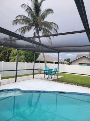Relax by the pool surrounded by lush tropical views and shaded by a transparent roof.