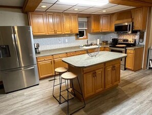 Enjoy cooking in this well-equipped kitchen with a large island, microwave, and oven.