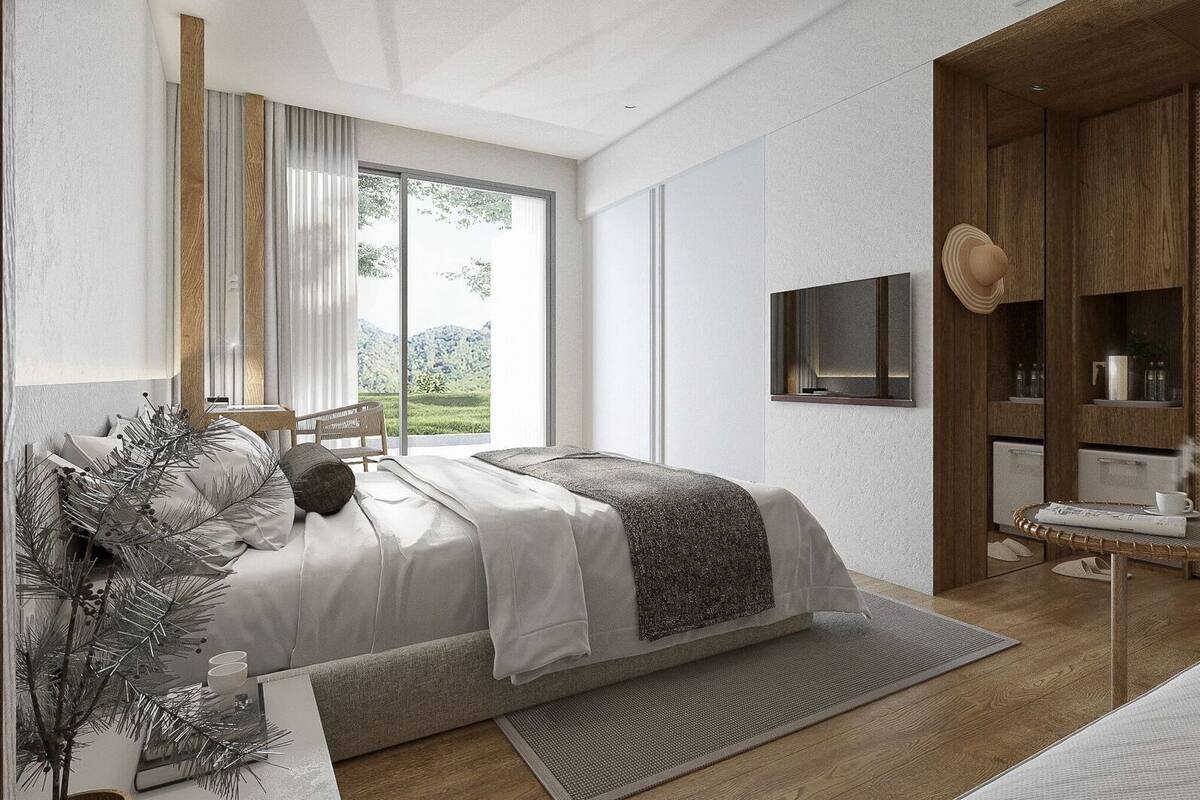 A modern bedroom with a bed, a window with curtains, a TV, and a wicker side table.