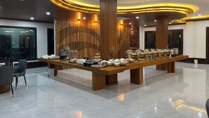 A modern hotel lobby with a long reception desk, wooden paneling, and a polished marble floor. - Xaymone Riverside Resort and Restaurant (Vang Vieng)