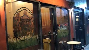 A restaurant named 'BOCCA' with outdoor seating and a glass wall featuring a mural. - House near the beach 4B/2Bath (San Juan)