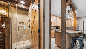 A modern kitchen with wooden cabinets, a central island, and bar stools.