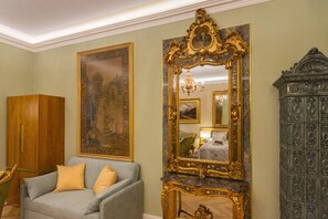A room with a large ornate mirror, a wooden cabinet, and a grey sofa with yellow cushions. - Superb Arena View (Pula)