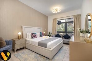 A bedroom with a bed, bedside tables, a dresser, a mirror, and a window with curtains. - Vogue | The Greens near Emirates Mall | Ski Dubai (Dubai)