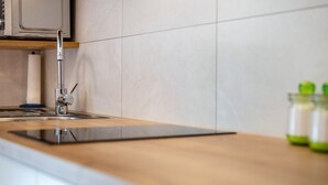 A kitchen with a modern faucet, a wooden countertop, and a paper towel holder. - Holiday Apartment "Talblick 3" with Mountain View, Garden and Wi-Fi (Lajen)