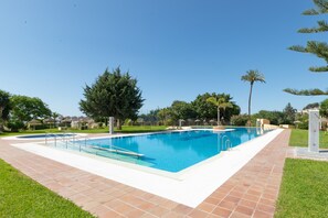 A rectangular swimming pool with a clear blue water surface, surrounded by a tiled deck. - Studio Apartment 'Torremolinos' with Shared Pool, Shared Garden & Wi-Fi (Málaga)