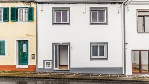 A row of buildings with multiple windows, doors, and a visible number '3' on one building.