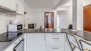 A modern kitchen with a microwave, oven, and cabinets.