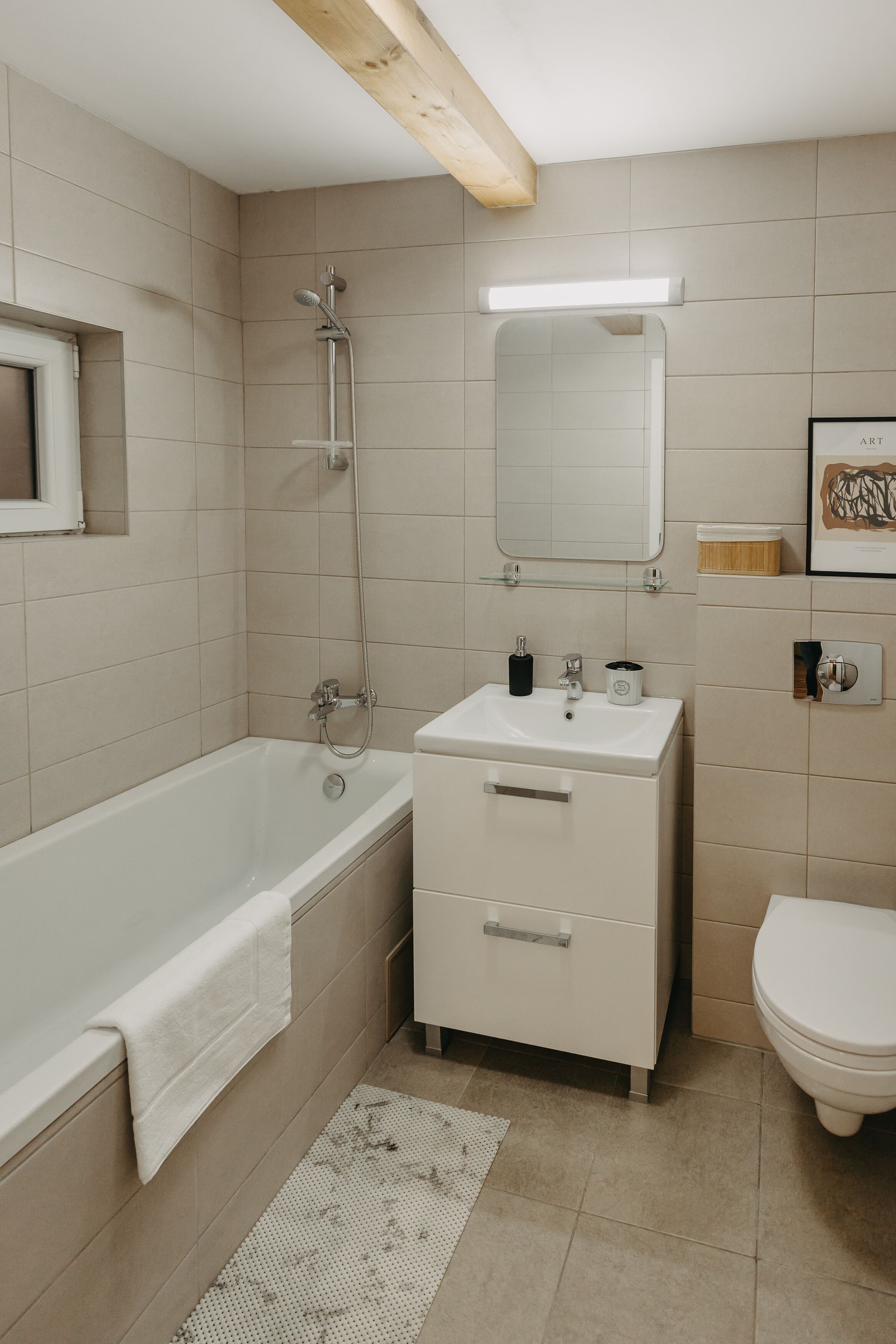 A modern bathroom with a bathtub, sink, and toilet.