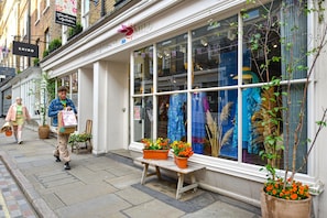 Experience the charm of this boutique hotel, featuring a classic facade with large windows and a welcoming entrance.