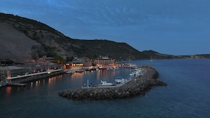 A coastal town with a marina, a prominent building labeled "MIRAYFORT," and rocky terrain. - Assos Troy Port Hotel (Ayvacik)