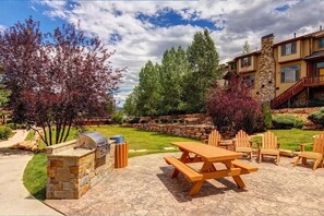 Relax in the serene outdoor patio area, complete with a barbecue grill and comfortable seating.