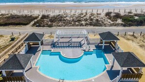 A pool area with a view of the beach and ocean. - The Hamptons #139 Brand new, Oceanfront B,  Hot Tub, Com. Pool! (North Topsail Beach)
