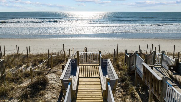 A wooden boardwalk leading to a sandy beach with a clear view of the ocean. - The Hamptons #139 Brand new, Oceanfront B,  Hot Tub, Com. Pool! (North Topsail Beach)