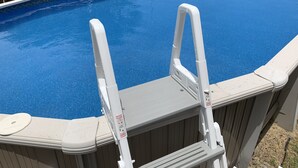 An above-ground swimming pool with a white ladder. - Bay View Bungalow By The Pier 4 Bedroom Home by RedAwning (Norfolk)