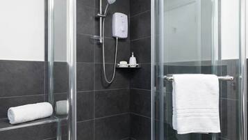 Shower, hair dryer, towels, shampoo