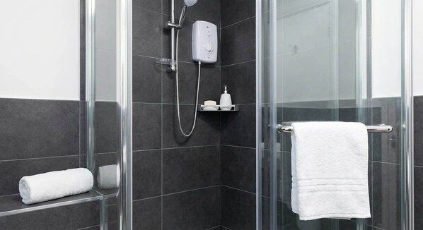 Shower, hair dryer, towels, shampoo