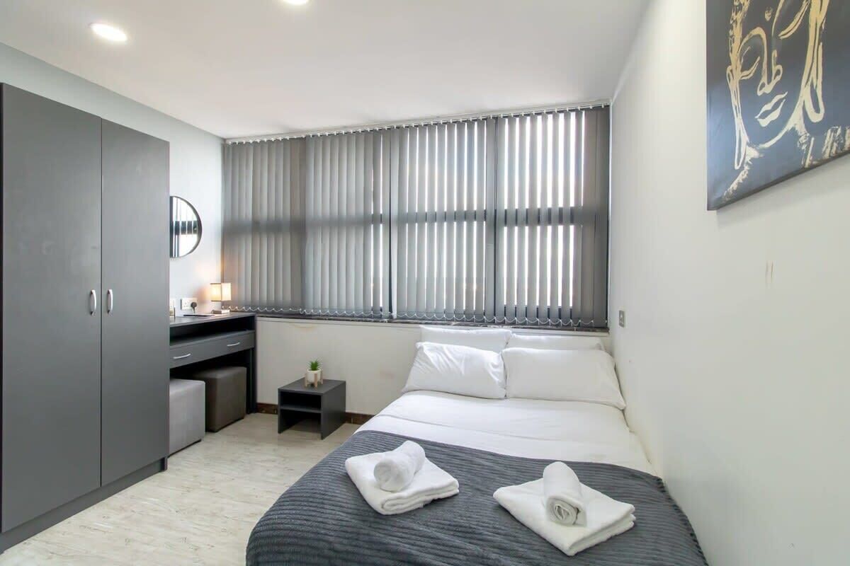 Desk, iron/ironing board, bed sheets