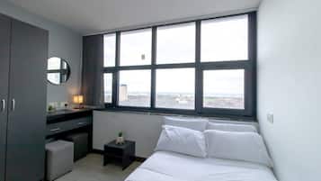 Desk, iron/ironing board, bed sheets